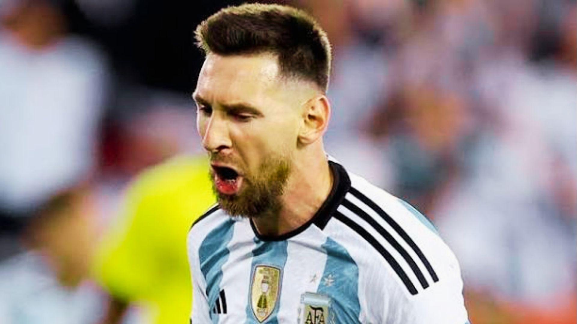 Lionel Messi with 2022 World Cup short faded haircut shouting in celebration wearing Argentina jersey
