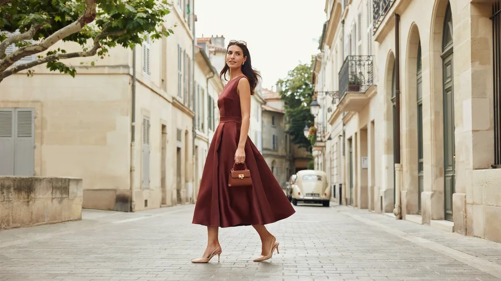 Woman wearing a drop-waist dress that visually lengthens the torso.