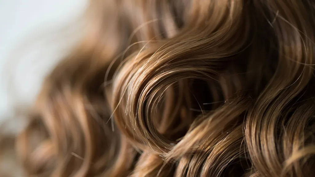 soft loose curls with natural texture and added root volume showing prepped hair with light waves and airy movement throughout strands.