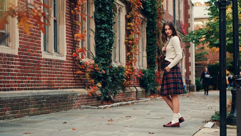 Plaid skirt and knit sweater styled for a classic preppy outfit.