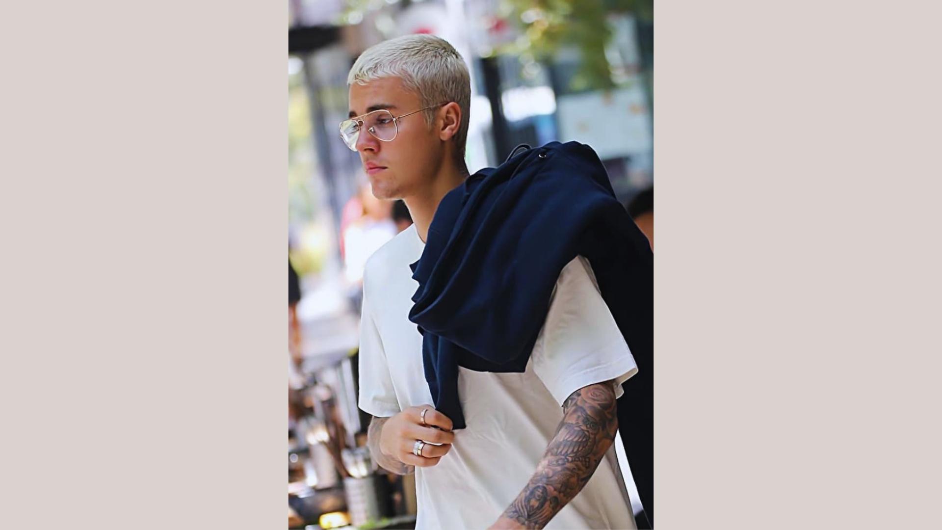 Justin Bieber blonde buzz cut with glasses street style, short dyed haircut.