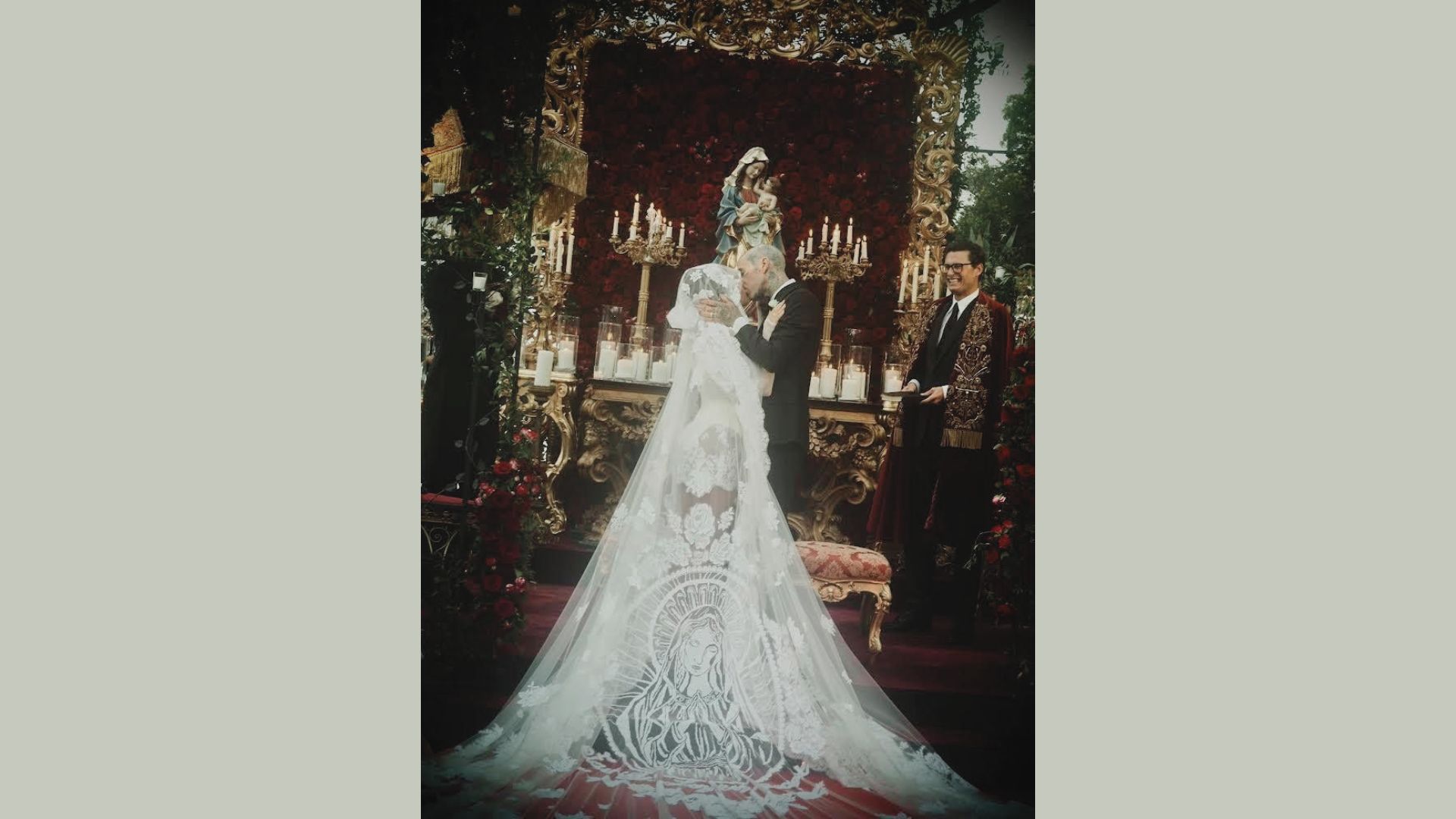 Bride wearing a short lace wedding dress with a long veil on castle stairs