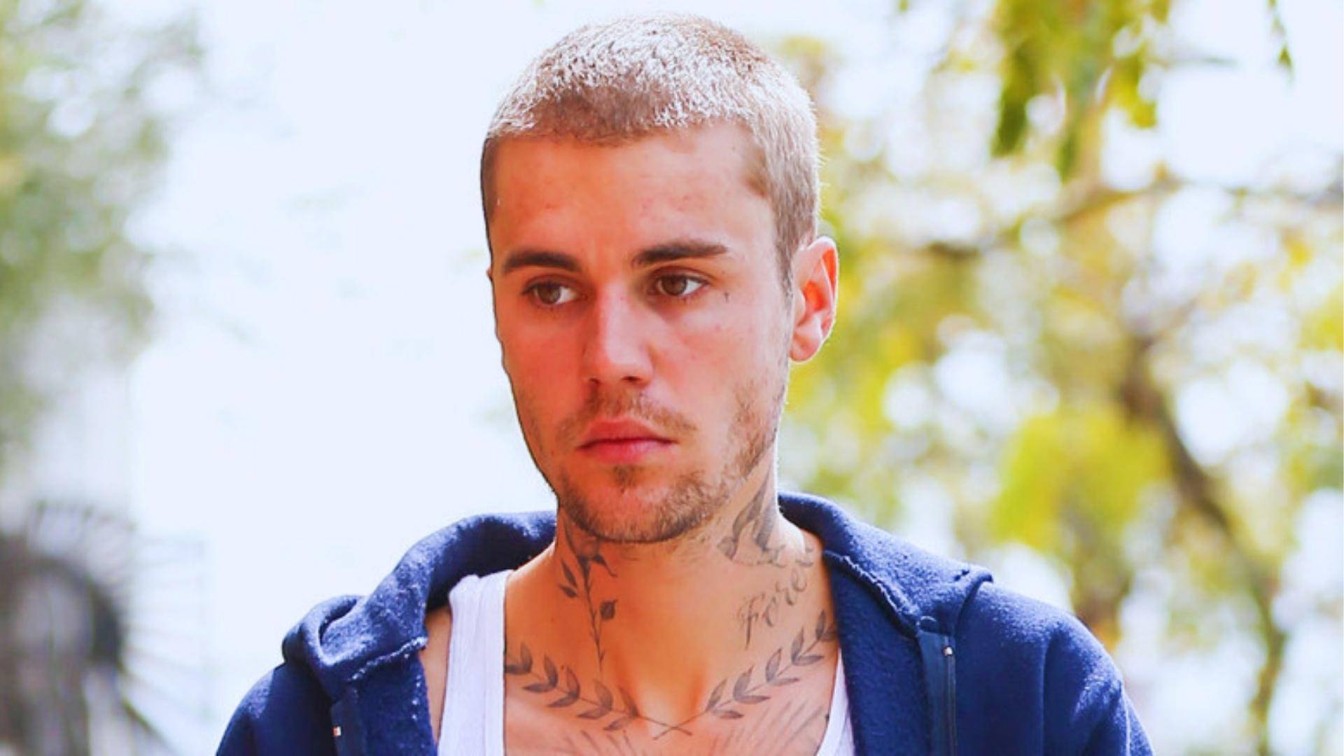 Justin Bieber bleached buzz cut blonde hair outdoor casual look, short cropped haircut.