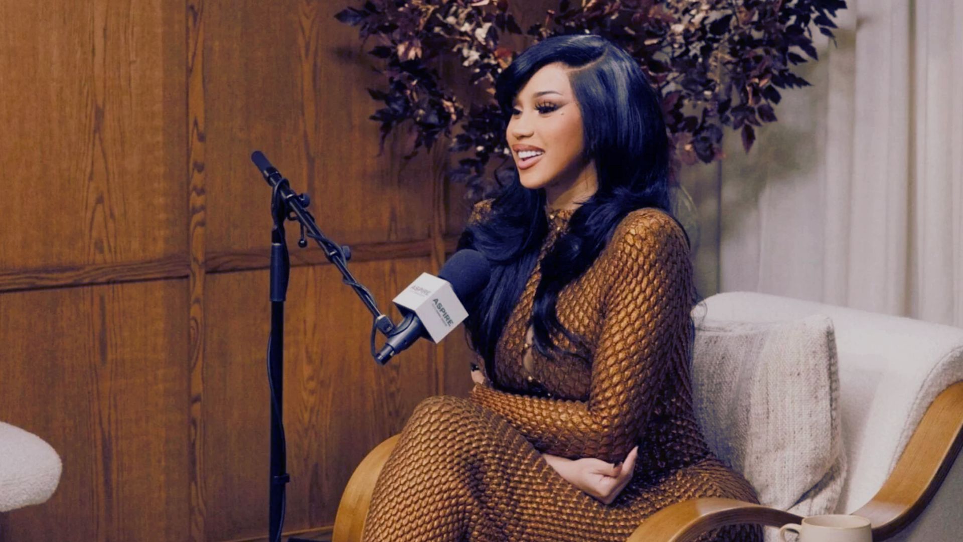 Cardi B embracing natural beauty and self-acceptance in a candid moment.