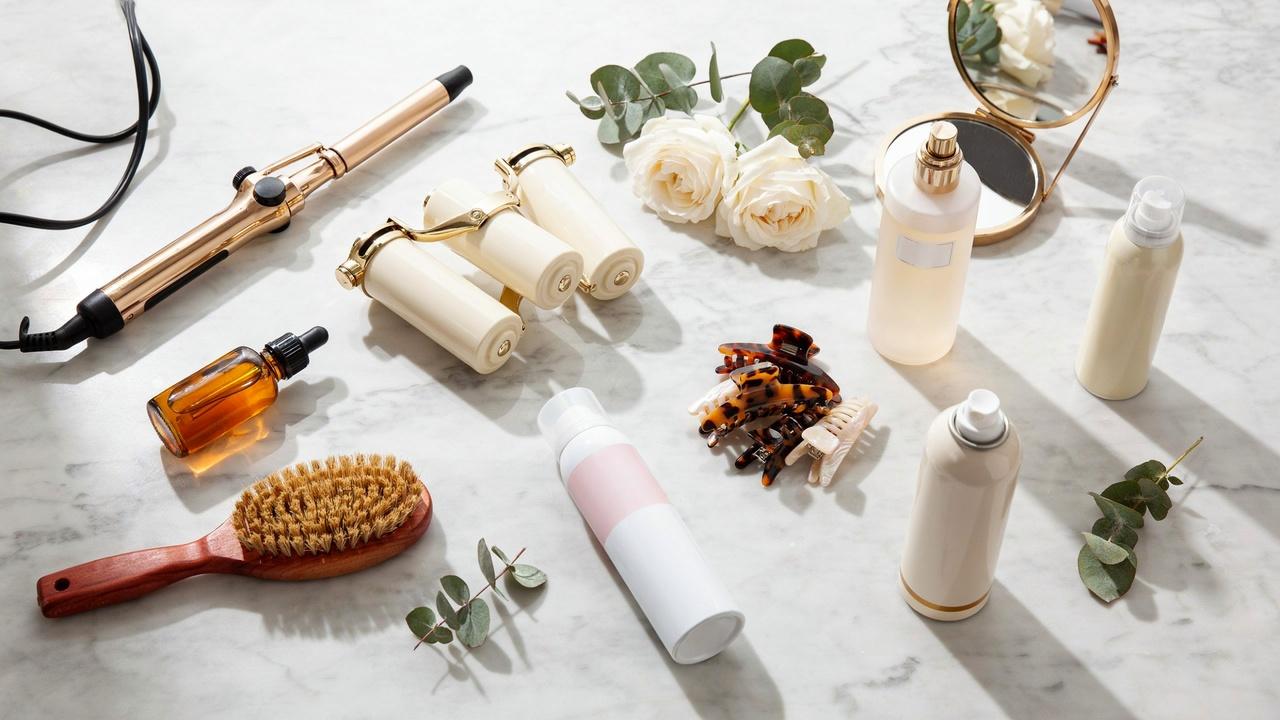 Veronica Lake hair styling tools including curling iron, hot rollers, brush, mousse, serum, and hairspray.