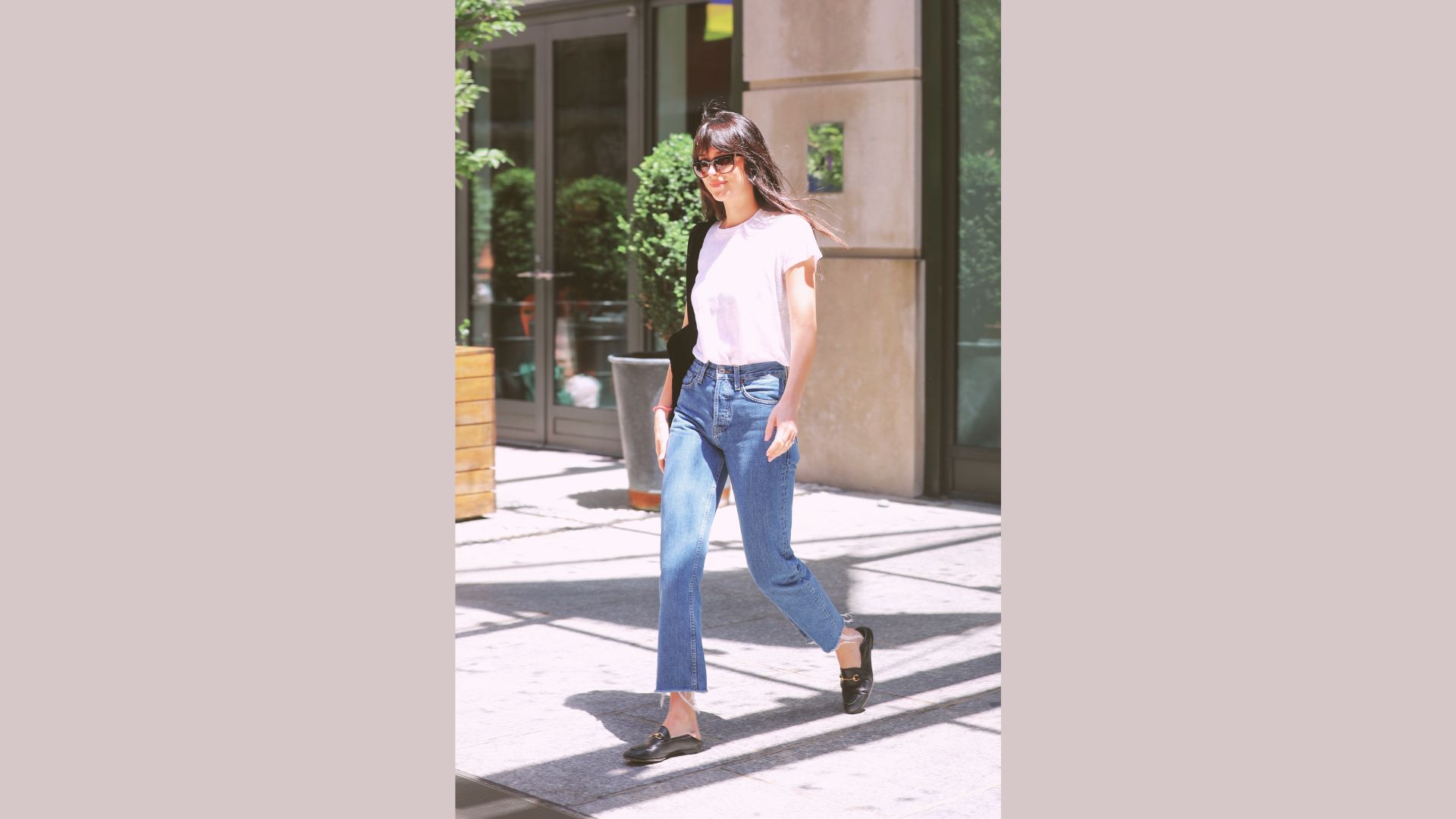 Model wearing light-wash straight-leg jeans.