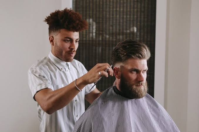 Showing a Bryce Harper haircut reference to a barber.