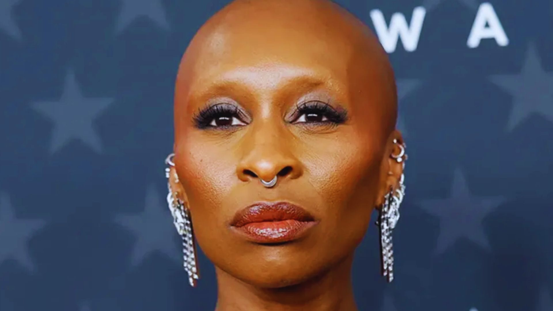 Cynthia Erivo showcases shaved head style, strong presence, and bold red carpet fashion during public appearance.