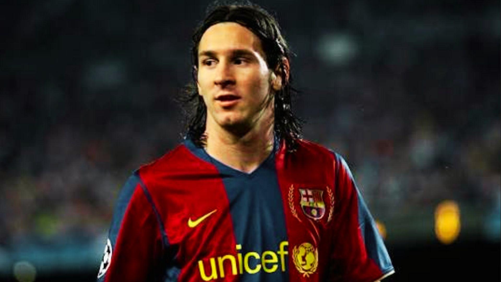 Lionel Messi with long wavy haircut wearing classic UNICEF Barcelona jersey