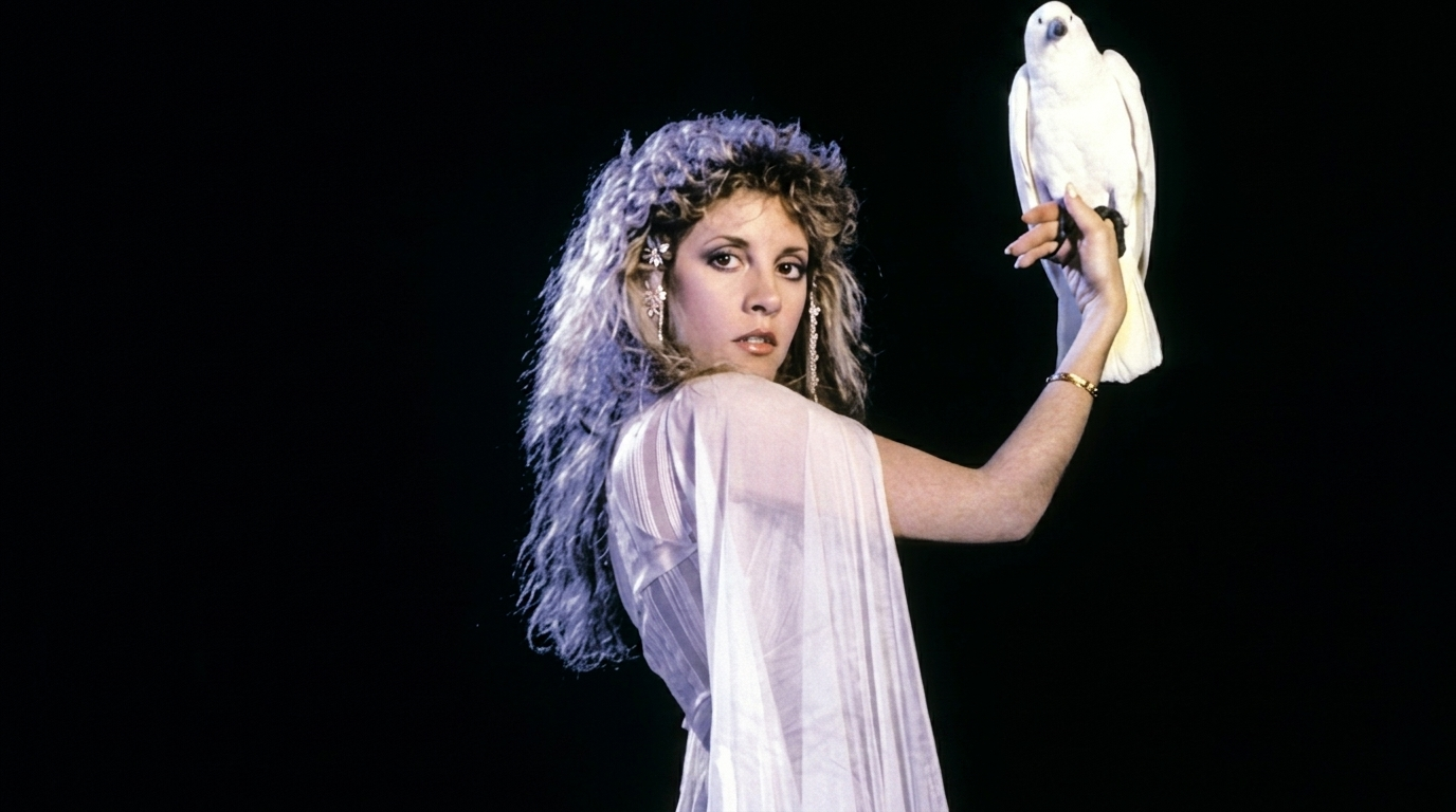 Stevie in white winged dove-influenced outfit.
