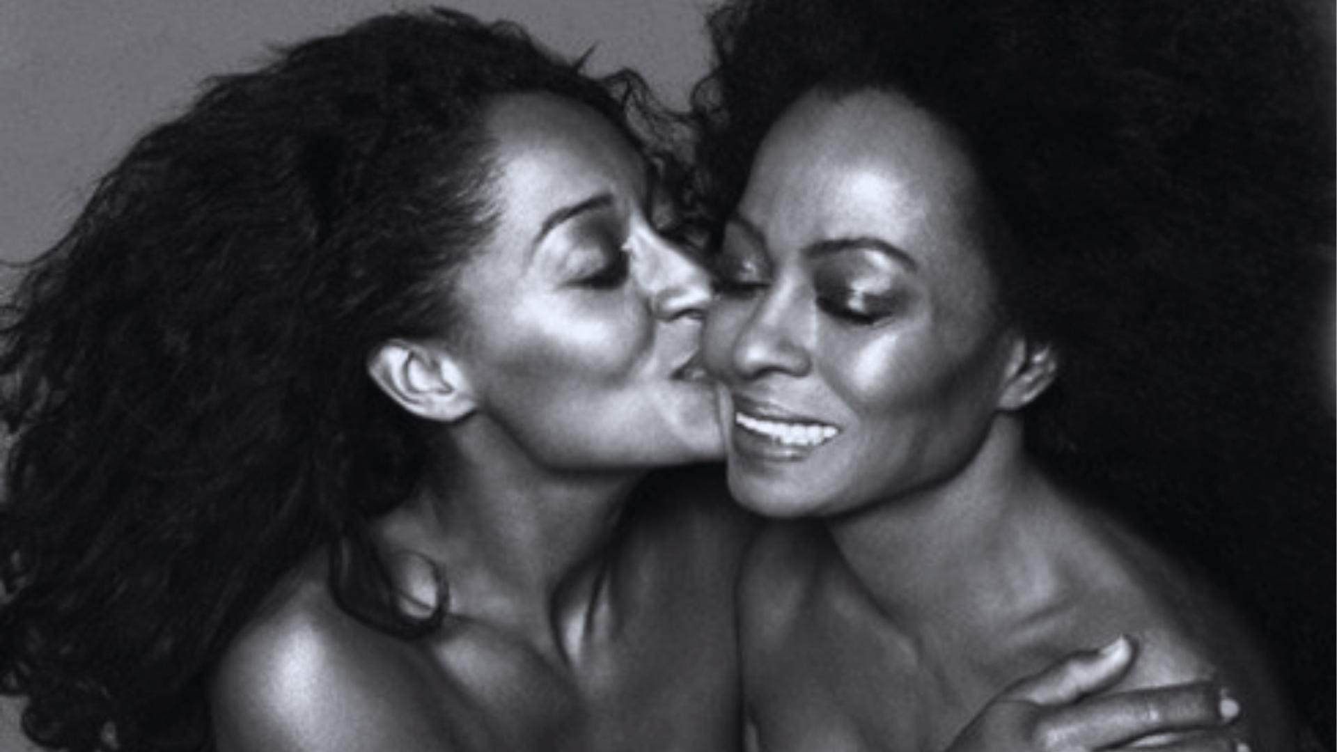 Black-and-white portrait of Tracee Ellis Ross kissing Diana Ross on cheek, both with full natural curls and bare shoulders.