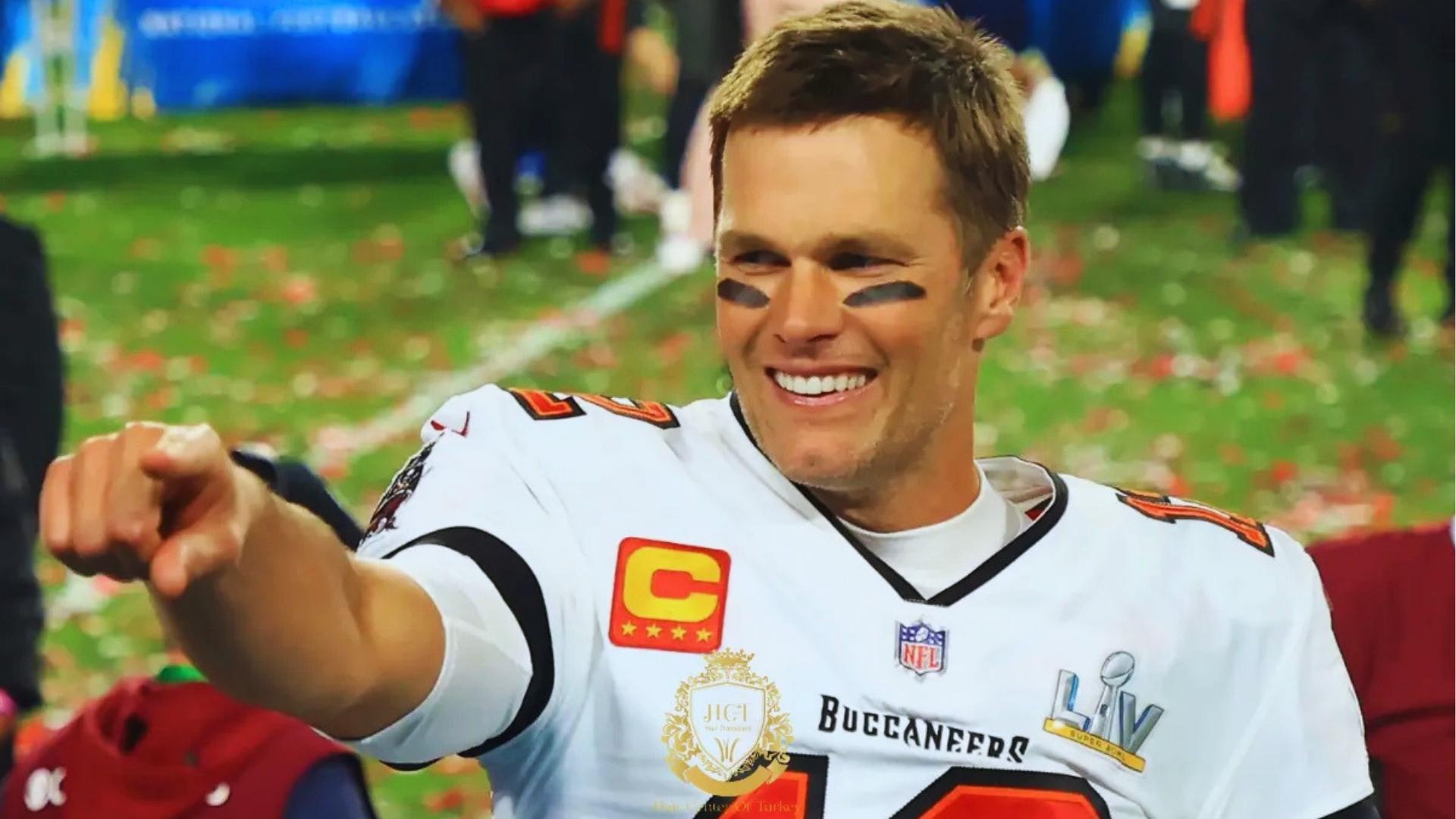Tom Brady in Tampa Bay Buccaneers uniform pointing on confetti covered field after Super Bowl LV.